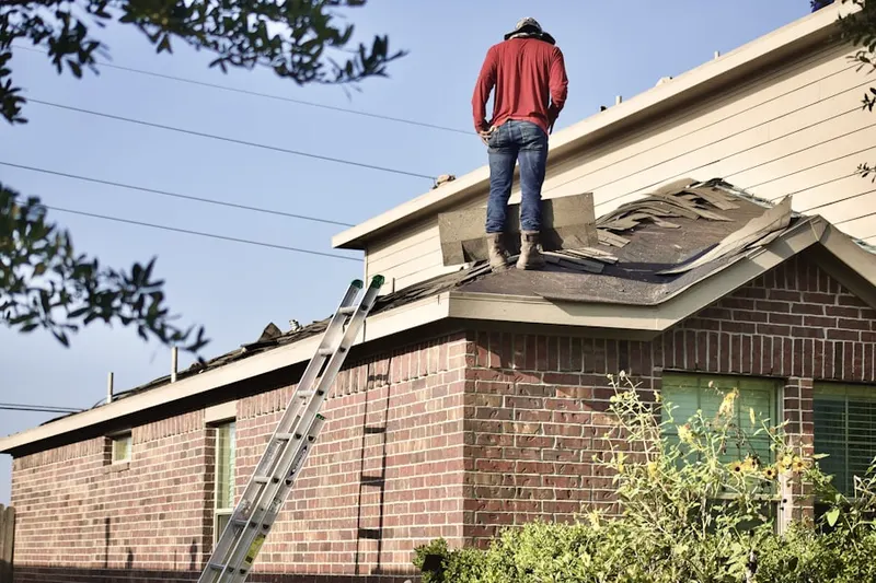 Professional roofer working on a residential roof in Johnson Woods